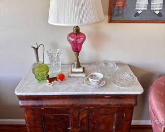 Marble-top table & cranberry glass lamp.