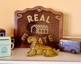 Collectible cast pipe holder & wooden real estate sign.