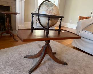 Antique claw foot coffee table with antique globe on top.