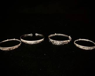 HAYE122 Four Chinese Sterling Bracelets Two ladies and two children's bracelets. Three have intricate interior patterns and slide adjustments. 
