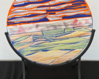 Vibrant charger plate on stand. 