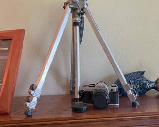 Camera tripod along with vintage Canon camera