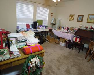Tablecloths, napkins, placemats, office supplies, sewing supplies, SINGER 257 Zigzag Sewing Machine - Very Strong - Denim Leather plus cabinet,  Sligh antique secretary desk with chair,  Small drop leaf dining table with two chairs, one drawer wooden desk, holiday decorations, books, baskets 


