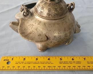 Antique chinese tea pot with writing all over it