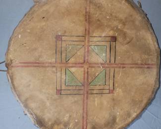 very old large native american deer hide drum with tribal painting / markings on each side. 