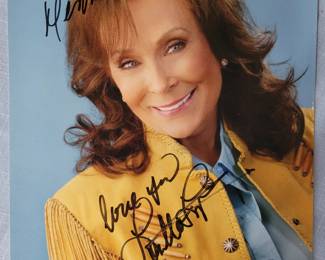 Loretta Lynn signed photo with Grand ole Opry history book