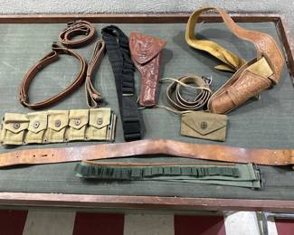 old gun holsters ammo belts.  large tooled leather holster is marked HH Heiser canvas pouches are ww2 era