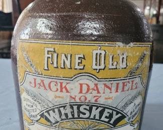 Old stoneware whiskey jug with Jack Daniels label