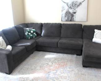 Charcoal gray sectional sofa. Showing some slight wear. Sections: left-96" W, middle 64" W, right lounger 36" W x 72" L.  BUY IT NOW!  $195.00.