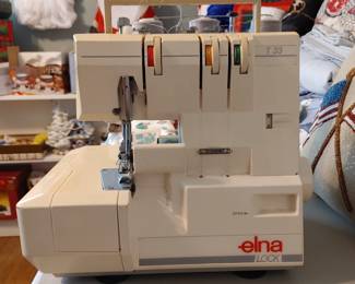 elna lock t-33 serger; 3 spools - works great! Includes owner's manual and carrying case!