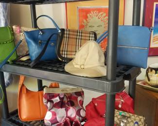 There are a number of Coach bags, Burberry bag and hat. Staff will assist at checkout. 