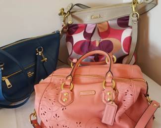 Coach purses. Some are at the checkout desk.