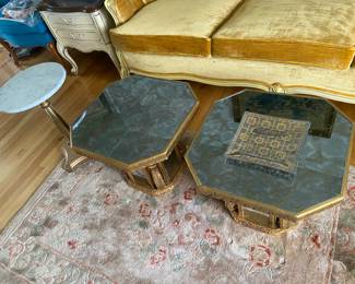 Pedestal coffee tables with gold trimmed mirrors on bass