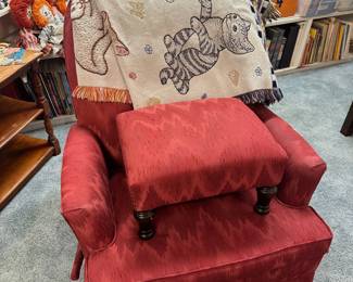 Red upholstered chair and ottoman