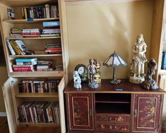 Asian storage center, vintage lamp, collectable statues, paperback books, recipe books, videos
