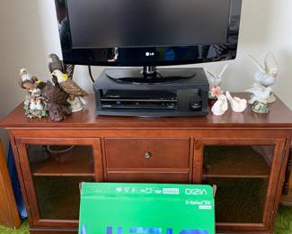 Two televisions, one brand new in the box.  Both are in great working order.  The entertainment center is free of stains and scratches.  