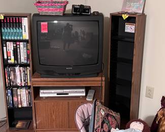 One of Four TVs Available  Shelving for CDs and VHS Cassettes  and An 
Assortment of Baby Equipment and Accessories 