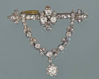 ANTIQUE LAUREL GARLAND BROOCH | 19th century, antique full cut and rose cut diamonds, designed as a bar-form pin mounting 27 diamonds suspending a laurel garland form section mounting 20 diamonds suspending a single diamond pendant - the garland section removable via a screw-type fitting on the back
2 in., 12.7g