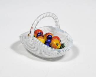 SAINT LOUIS BLOWN GLASS FRUIT BASKET | St. Louis paperweight, blown glass in the form of a fruit basket with twisted handle, marked on base - l. 3.5 x w. 2.5 x h. 2.5 in.
