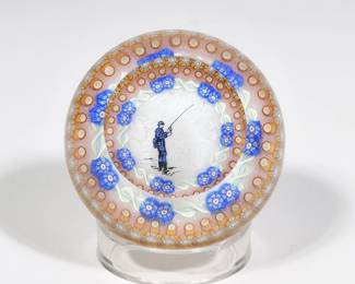 PERTHSHIRE ART GLASS FISHERMAN PAPERWEIGHT | Showing a fisherman before a white patterned background in a circle of millefieure decorations - h. 2 x dia. 3 in. (overall)

