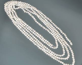 VERY LONG STRAND OF BAROQUE PEARLS | Designed as a very long knotted strand of (approx. 6.5mm) baroque white pearls; 104 in.