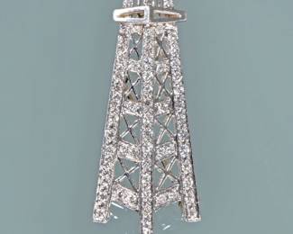 DIAMOND & PLATINUM OIL DERRICK PENDANT / PIN | Designed as a finely detailed oil derrick mounting melee diamonds with a pin back and loops for a chain; 1.5 in., 5.8g