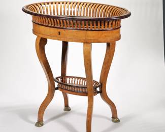 GEORGIAN / REGENCY RETICULATED JARDINIERE | Oval wooden veneered and inlay decorated jardiniere with a brass insert, lower carved shelf with cabriole legs and brass claw feet
 - l. 29 x w. 18.5 x h. 29.5 in.
