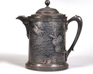 LARGE HAMMERED MERIDEN SILVERPLATE TANKARD | Hammered with applied decorations of swans and flowers
 - l. 10 x h. 11 in.