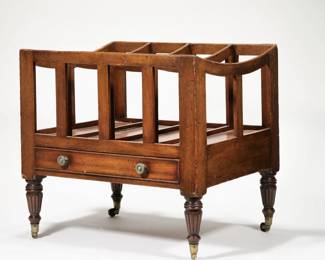 ANTIQUE WOOD CANTERBURY | Having four equal partitions with curved top over a full-width drawer with round brass pulls and cockbeading, raised on turned and fluted legs with brass casters. - l. 21 x w. 16.25 x h. 19.5 in.
