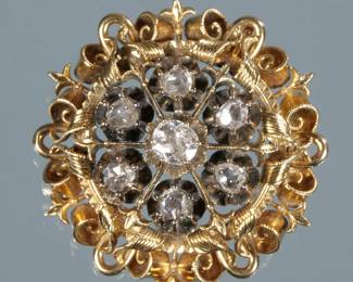 ANTIQUE FLOWER HEAD BROOCH | Designed as a round gold openwork gallery with engraved scrolls, ropework, and fleur-de-lis, the center mounting six rose cut diamonds and a central .5 ct old mine cut diamond (5.1 x 4.7 x 2.4 mm) 1.5 in., 17.4g 
 - dia. 1.5 in.
