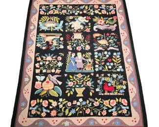 AMERICAN PICTORIAL HOOKED RUG | 20th Century, showing birds among flowers and vines with an amorous couple and Cupid signed "CM" 
l. 74 x w. 55 in.