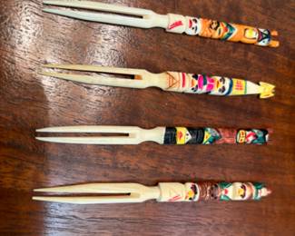 Native Indigenous Alaskan set of carved olive forks from walrus tusk, circa 1957.