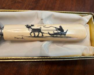 Scrimshaw cake server handle by Robert Mayokok.