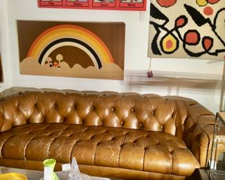 Chesterfield brown leather sofa, , fabric wall artwork, lucite waterfall  table