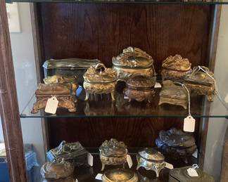 Curio cabinet full of antique jewelry boxes