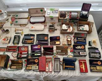 A table full of vintage shaving paraphernalia.  Not shown is the closed cabinet full of straight razors!