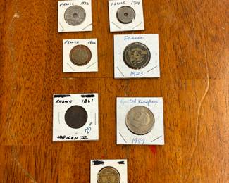 Assortment of coins in white coin holders