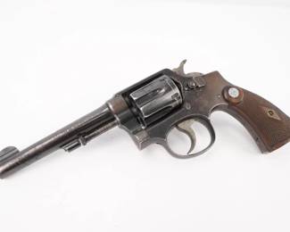 Make: SMITH & WESSON
Model: M and P
Caliber: 38 S&W SPL CTG
Action: DA
Barrel: 5
Bore: Bright
Serial # 397150
Condition: Very Good
Smith and Wesson 1905, or M&P and or Pre model 10. No mater what you call in, it is a classic Smith & Wesson revolver in 38 Special. This one has 5 inch barrel. It is a 5 screw revolver. The Smith & Wesson log is located on the left side of the frame. The stocks are wood with diamonds and silver medallions. The bore is described as bright. The pistol shows normal signs of use and wear.