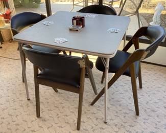 Card table with four vintage chairs