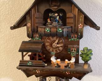 Musical cuckoo clock with many working parts