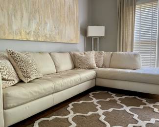 Pre-Sale $600.00...Cream colored leather sectional with tufted seat cushions (decorative pillows sold separately).                      
115w x 31h x 84d chaise/ 38d sofa