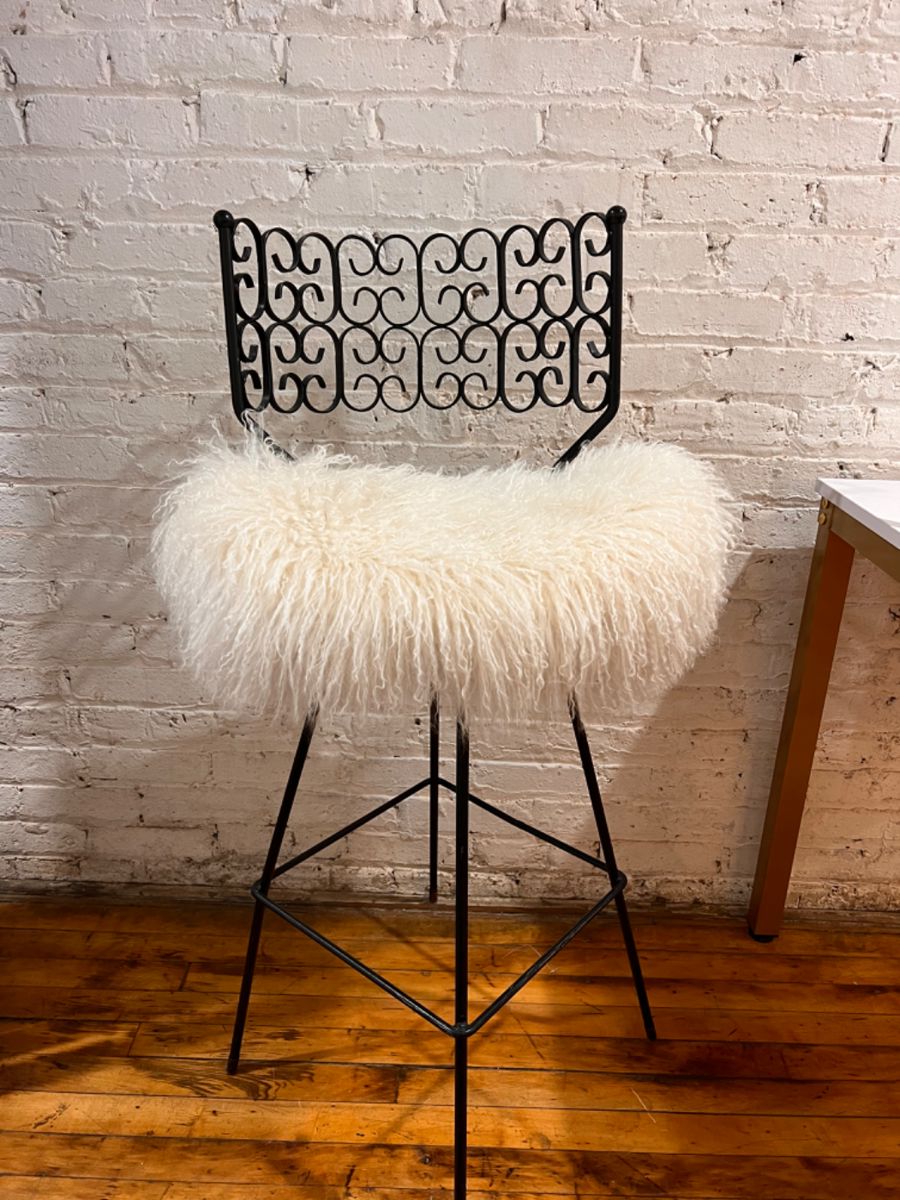 Arthur Umanoff for Shaver Howard Mid Century Iron swivel bar stool.  $800 on line $325.  Seat needs a few screws and is upholstered in real Mongolian fur.