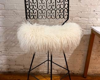 Arthur Umanoff for Shaver Howard Mid Century Iron swivel bar stool.  $800 on line $325.  Seat needs a few screws and is upholstered in real Mongolian fur.