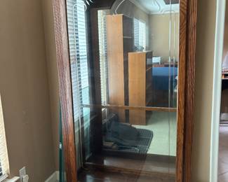 Several lighted  large curio cabinets with glass shelves 