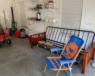 In the garage. Gator chair, Futon, Christmas decor, wagon, shop vac , yard tools