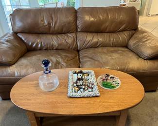 Leather couch, antique oval coffee table, vintage horse and farm animal toys, Blenko decanter with original sticker