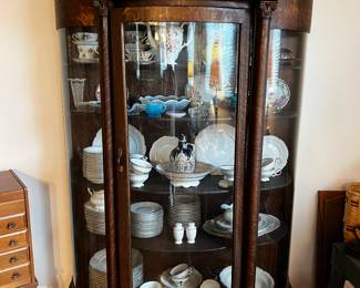 CURVED FRONT CHINA CABINET LOADED WITH CHINA