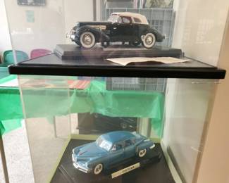 Model cars in viewing case. 