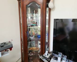 Wood corner curio cabinet with glass shelves. 