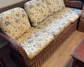 Four-piece rattan set - sofa, love seat, chair and ottoman.